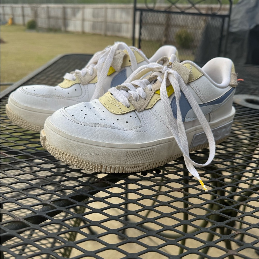 Nike Air Force 1s with blue and yellow details